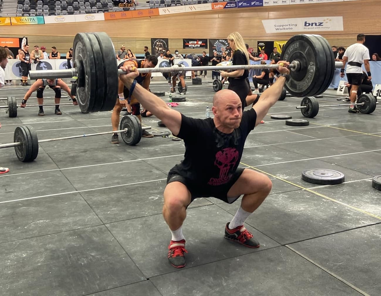 A photo of Coach Ryan Campbell doing a snatch in a CrossFit competition